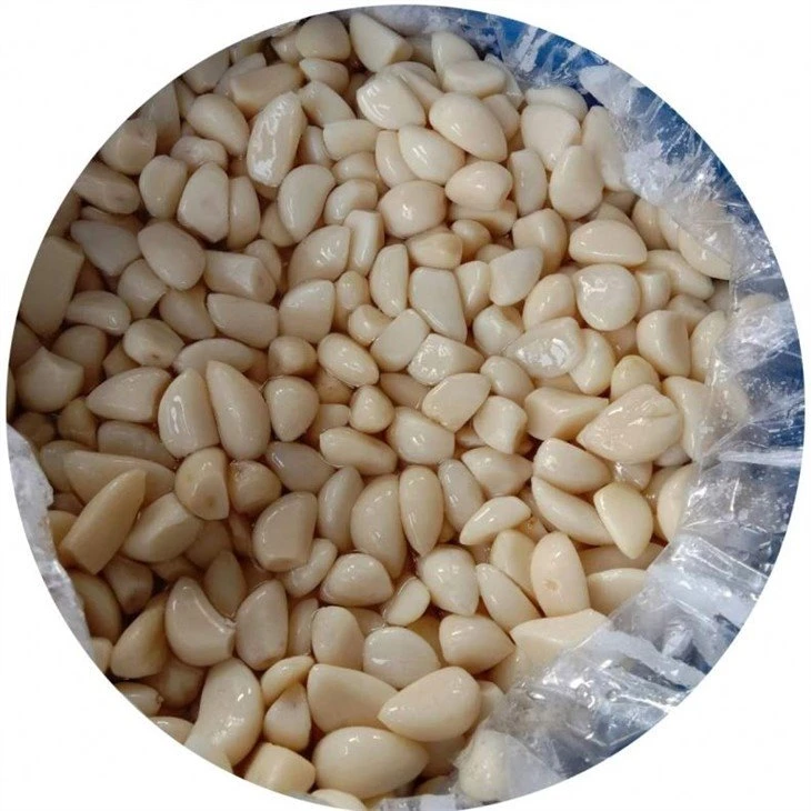 Peeled white garlic cloves in salted water