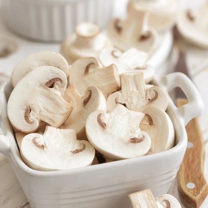Sliced white mushroom in brine in drums